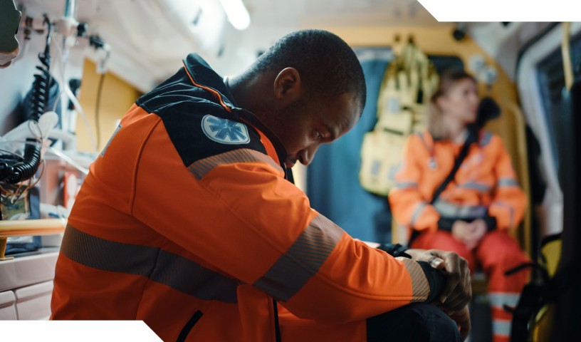 Emergency medical technicians looks down, during transport