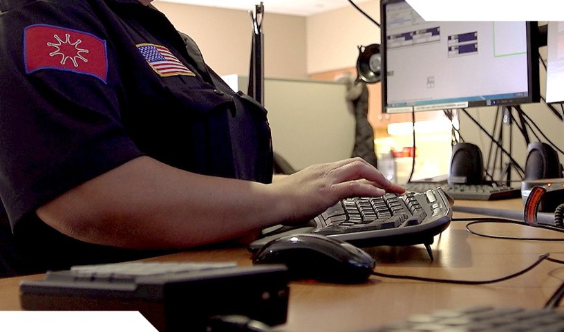 Closeup of tribal first responder typing on keyboard.