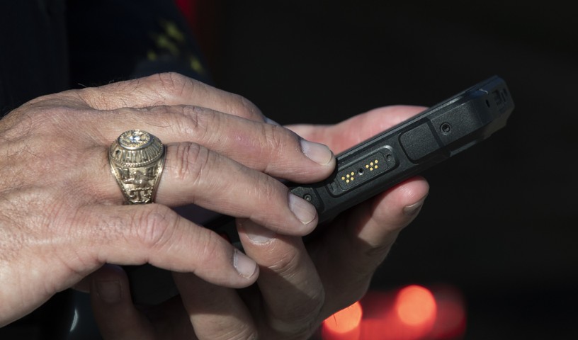 Close-up of two hands holding a mobile device