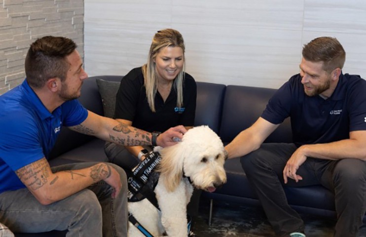 Group of people petting ROG the Dog